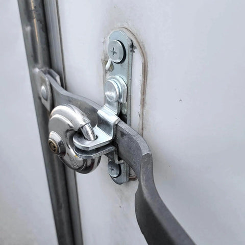 Close-up of Cargo Trailer Door Hasp Keeper Bar Lock Handle For Enclosed Car Hauler Ramp Gates Cam Latch Lock with screws and nut.