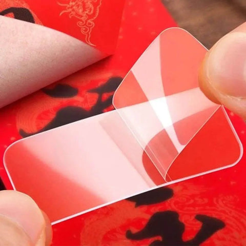 Double Sided Adhesive Pads Square Transparent Tape Cuttable For Walls Hangin Waterproof Gel Sticker Removable And Strong Hold Great For Power Strips Hooks Storage Boxes Carpets Picture Frames And More 60 Pcs In One Box being peeled.