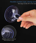 Hand holding a transparent PVC aquarium suction cup, showing flexible grip, 45mm vacuum ring for secure attachment on glass surfaces.