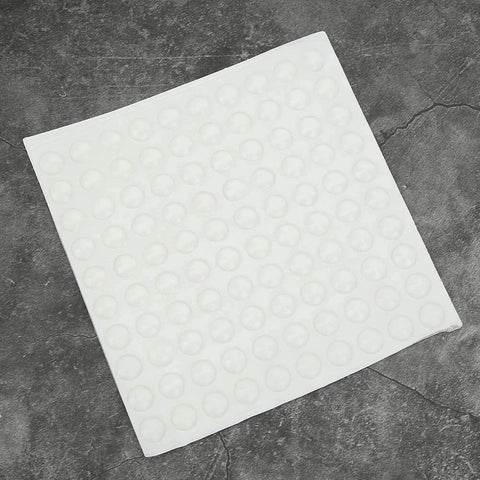 Self Adhesive Anti Slip Silicone Bumpers 200 Pcs Transparent Foot Pads sheet shown on a stone surface