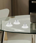 Glass table with 10 Pack Transparent Suction Cups With M6 Screws Nuts Grab And Go Anti Slip Vacuum Grip Hooks showcased on surface.