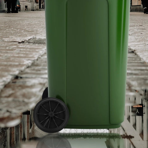A green outdoor trash bin with installed 7-inch rubber wheels designed for easy transport on patios and driveways.