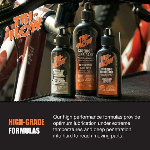 Tri-Flow Superior Lubricant bottles on a bike frame, showcasing high-grade lubrication for extreme temperatures.