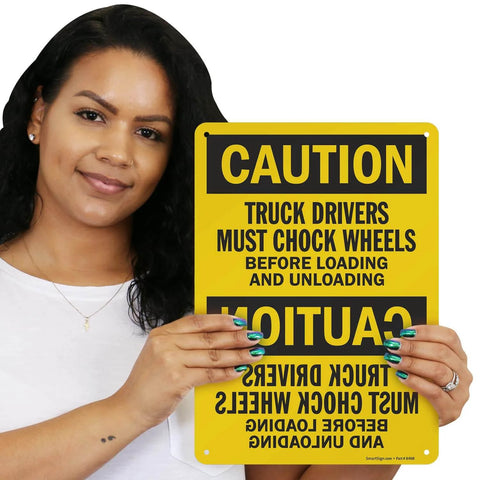 Person holding Truck Drivers Must Chock Wheels Before Loading And Unloading Sign 10 x 14 Aluminum Safety Sign for Yard Dock