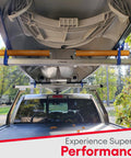 Kayak secured with polyurethane coated roller bracket on truck rack for smooth transport