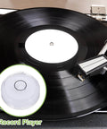 Black vinyl record on turntable with white center and stylus arm, inset image of round bubble level with "Record Player" text