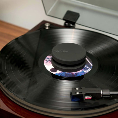 Turntable with improve vinyl sound and reduce surface wobble with a cork platter mat and a 760 gram steel weight, securing the record.