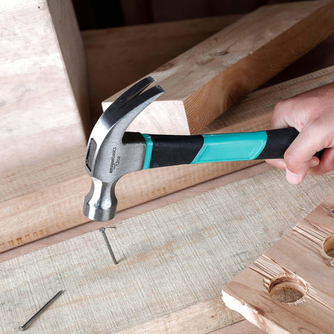 104 Piece Home Repair Tool Set With Easy Carrying Pouch For DIY Projects And Everyday Fixes Includes Hammer Pliers Magnetic Screwdrivers And Bits Wrenches Utility Knife Level And More In A Turquoise Portable Kit hammer in use driving a nail into wood