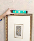 Adjusting picture frame with level from 104 Piece Home Repair Tool Set With Easy Carrying Pouch For DIY Projects And Everyday Fixes