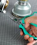 Close-up of hand using pliers from 104 Piece Home Repair Tool Set With Easy Carrying Pouch For DIY Projects And Everyday Fixes