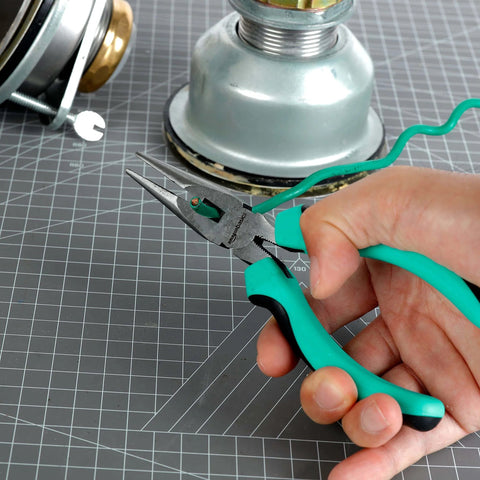 Close-up of hand using pliers from 104 Piece Home Repair Tool Set With Easy Carrying Pouch For DIY Projects And Everyday Fixes