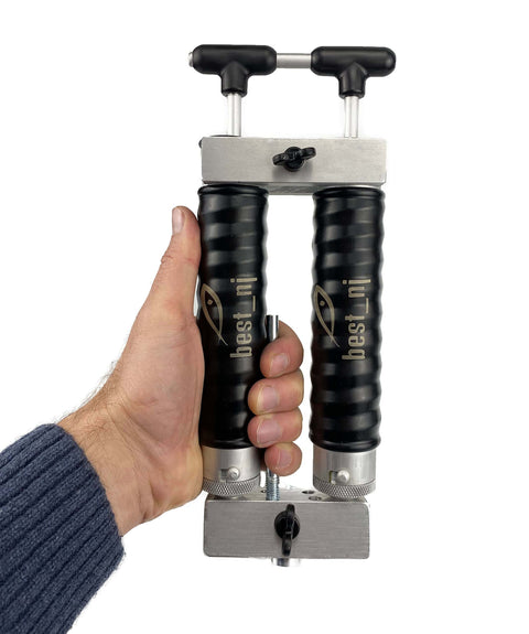 Hand holding Twin 120 Milliliter Aluminum Injector Mixing Set for soft plastics, featuring twin reservoirs and locking nozzle.