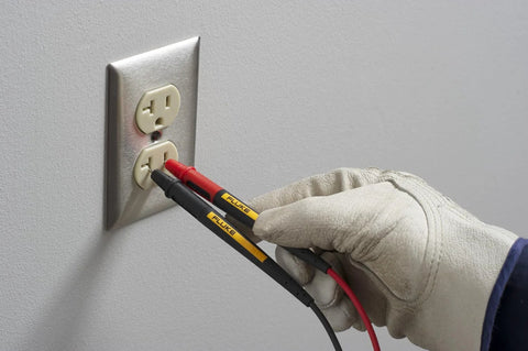 Twistguard Test Leads, 2 mm Diameter Probe Tips in use with an electrical outlet, showcasing rugged extendable design for safe measurements.