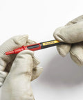 Hands holding Twistguard Test Leads, 2 mm Diameter Probe Tips with wear-resistant insulation, focusing on tip detail.