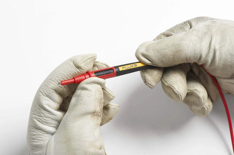 Hands holding Twistguard Test Leads, 2 mm Diameter Probe Tips with wear-resistant insulation, focusing on tip detail.