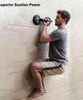 Man using Two Cup Pro Grade Aluminum Suction Cup Glass Lifter with High Vacuum Grip on wall surface, demonstrating suction power.
