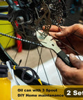 Two Pack Metal Yellow Pump Oil Can With Three Spouts For Precise Lubrication In Tight Gaps shown in use on bicycle maintenance