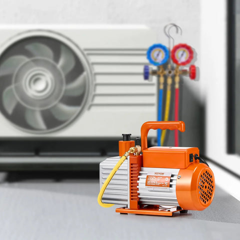 Two-stage 6 CFM vacuum pump for auto AC systems next to air conditioner and gauge set, professional HVAC tool.