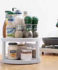 Two Tier Rotating Lazy Susan Organizer with Non Skid Base holding condiments and spices on kitchen countertop, 10 inch turntable.
