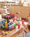 Two Tier Rotating Lazy Susan Turntable Organizer on table with snacks and drinks at a party, 12-inch wood design for kitchen or pantry storage.