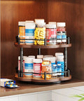 Two Tier Wood Lazy Susan Spice Rack Organizer with 360 Degree Rotating Turntable holding jars in a cabinet