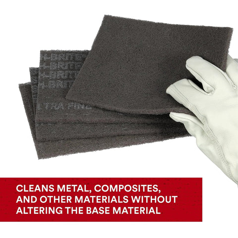 Gloved hand holding Ultra Fine Hand Pad 6 X 9 Inch Nonwoven Silicon Carbide for Surface Prep and metal finishing