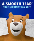 Bear holding Ultra Soft Toilet Paper Mega Roll Pack With Six Mega Rolls Equaling 24 Regular Rolls, highlighting soft texture.