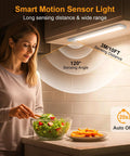 Woman chopping salad under 10.2 Inch Under Cabinet Lighting Kit Rechargeable 2 Pack with Motion Sensor in kitchen.