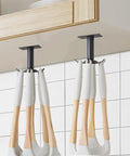 2 Pcs Under Cabinet Metal Utensil Hanger with 6 Rotatable Claws, holding kitchen tools, mounted beneath a wooden cabinet.