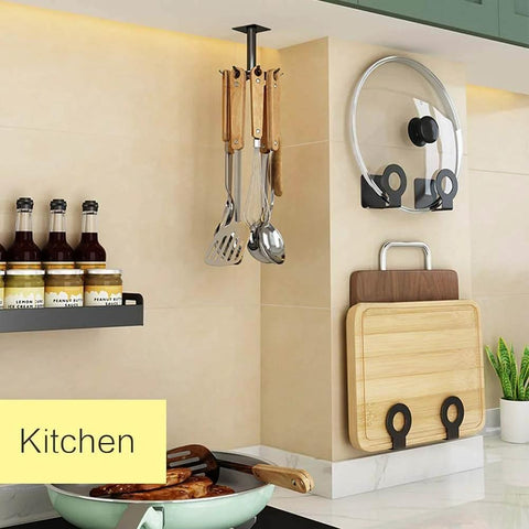 Kitchen showing 2 Pcs Under Cabinet Metal Utensil Hanger with 6 Rotatable Claws, top mounted near cutting boards and jars on a countertop.