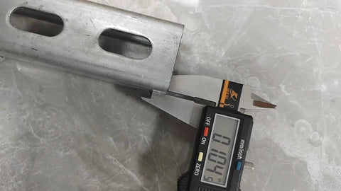 Close-up of a Unistrut Channel Trolley Track, 57 in (4.75 ft) 1-5/8" x 1-5/8", 12 Gauge Steel U-Channel, Galvanized Finish, with slotted back, measured with a caliper.