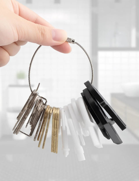 Hand holding Universal Dispenser Key Set For Paper Towel, Toilet Paper, And Soap Dispensers With 29 Replacement Keys Fits Most Brands