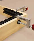 Milescraft 7209 universal fence clamp, installed side view; silver aluminum body, red knobs