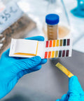 Person using 2 Pack pH Test Strips, 160 Strips pH.1-14 Universal pH Test Paper Litmus Test Paper in a lab setting