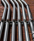 Ten-piece universal tube clamps deliver secure, corrosion-resistant support for Unistrut channels; 2 inch wall mount conduits, bolts and nuts included, galvanized steel for long lasting electrical and plumbing runs