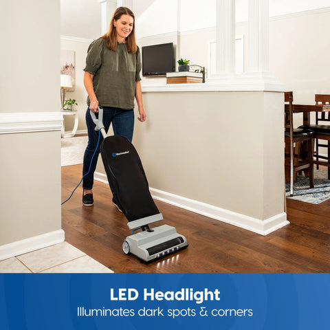 Person using Ultra Lightweight 14L Bagged Upright Vacuum Cleaner with LED Headlight and 2 Speed Settings on hard floor