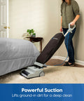 Person using Ultra Lightweight 14L Bagged Upright Vacuum Cleaner With LED Headlight And 2 Speed Settings for carpets