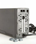 Back view of UPS with cables and four self adhesive bumper feet 0.780 in by 0.380 in black square polyurethane pads nearby