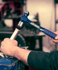 Person using Ball Peen Hammer 24 Oz USA Made With Forged Steel Construction And Shock Reduction Grip for metalworking on automotive part