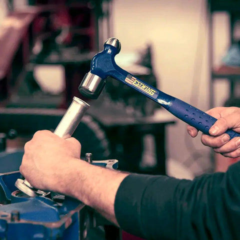 Person using Ball Peen Hammer 24 Oz USA Made With Forged Steel Construction And Shock Reduction Grip for metalworking on automotive part