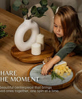 12 inch acacia wood lazy susan turntable with removable glass plate, featuring a child serving cheese on a marble texture tray.