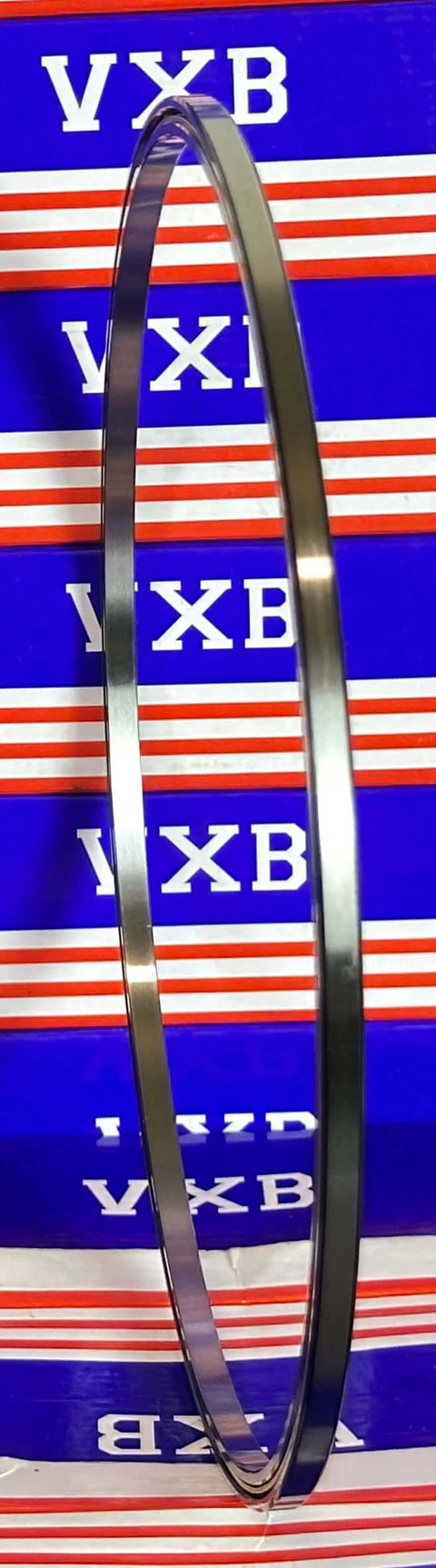 VA090CP0 Thin Section Bearing 9" x 9-1/2" x 1/4" inch chrome steel ring side view on blue background.