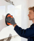 Person using an 8-Inch Heavy-Duty Vacuum Suction Cup Lifter With ABS Handle, 400 lb Max Lift Capacity for tile installation.