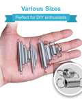 Hand holding various sizes of metal tension springs for DIY projects