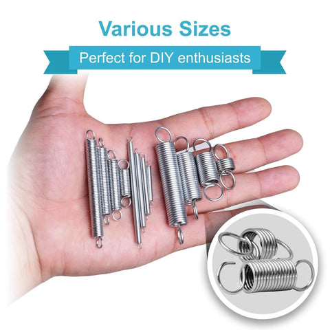 Hand holding various sizes of metal tension springs for DIY projects