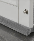 Velvet Under Door Draft Stopper With Adjustable 30 To 36 Inch Gap, Double Sided Windproof Seal installed under a white door.