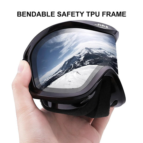 Hand holding ski goggles with silver lens showing mountain reflection, bendable safety TPU frame, ski goggles with ventilation anti fog system for men and women