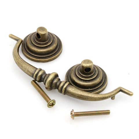 Four Piece Vintage Antique Brass Bail Pull Handle Set for Wooden Drawers Cabinets and Cupboards, close-up view of zinc alloy hardware.