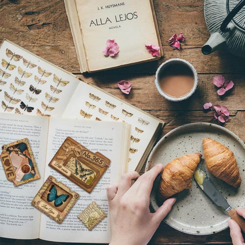 Awesome Versatile Die Cut Set For Card Making And Scrapbooking With Folder Slide Stamp Film Patterns Envelope Cut Dies Journal Embellishments And Paper Craft Decor For Diy Projects By Globleland displayed next to books, tea, and croissants on a wooden table.