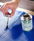 Applying HH-66 vinyl cement on blue patch from Ultimate DIY Pro Grade Vinyl Repair Patch Kit for Commercial Inflatables.